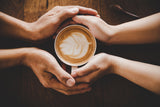 A coffee passed on to someone, in person